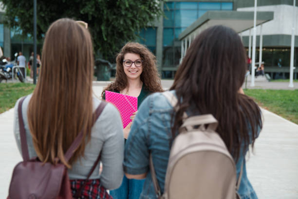 istock Curly hair female student in front of university campus 1201218517
