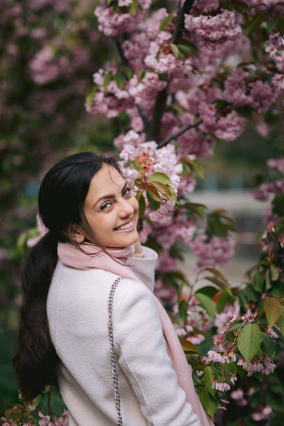 istock brunette woman enjoying spring day in park 1201218736
