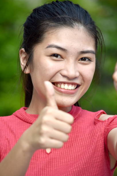 istock Beautiful Asian Youth With Thumbs Up 1201219079