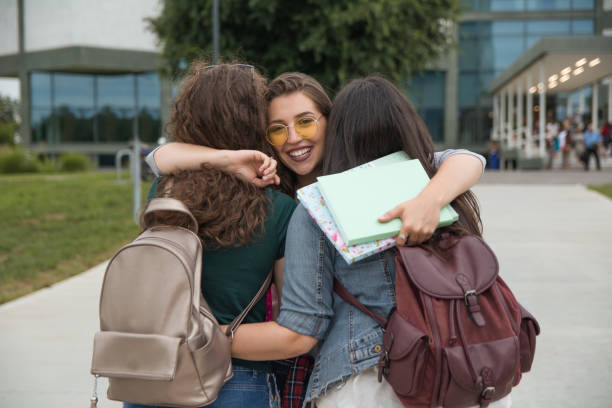 istock Female friends hugging in front of a University campus 1201219116