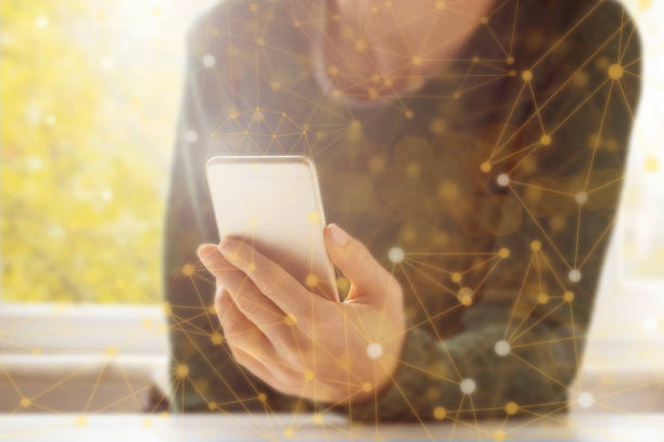 istock Woman using her phone with hologram effect. 1201222797