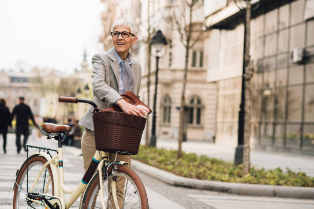 istock Senior businesswoman commuting with her bicycle 1201223019