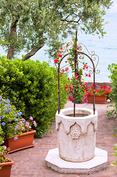 istock flower garden with stone well 120122543