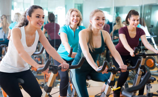istock Females riding stationary bicycles 1201225599