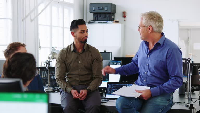 Boss congratulating successful male employee with promotion