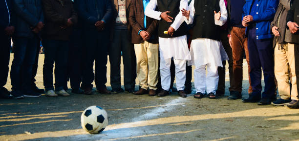 istock Group of people standing around a soccer field 1201227466