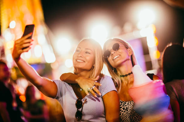 two girls taking selfie at the music festival two girls taking selfie at the music festival 3686 stock pictures, royalty-free photos & images