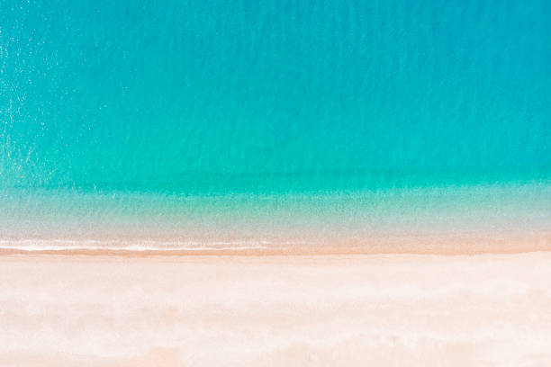 istock Flying over an empty sandy beach and beautiful emerald ocean waves. 1201237592