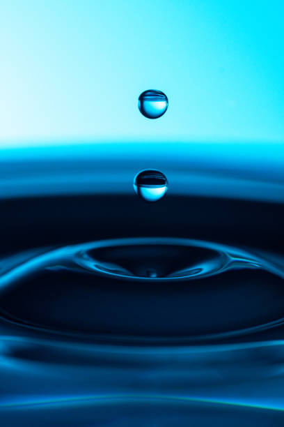 istock Two blue drops on a blue background with blue water 1201238146