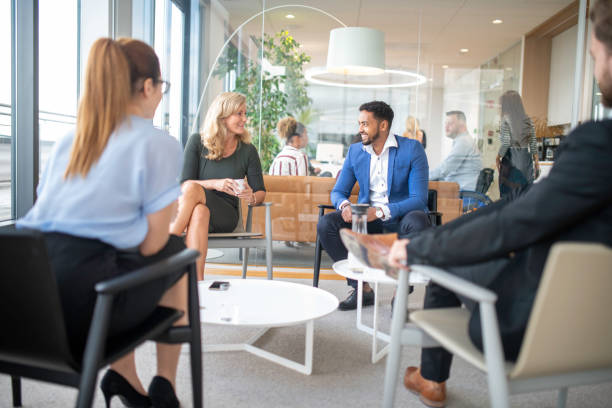 istock Business people talking in an office lobby 1201240502