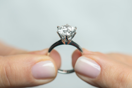 Woman showing a diamond ring.