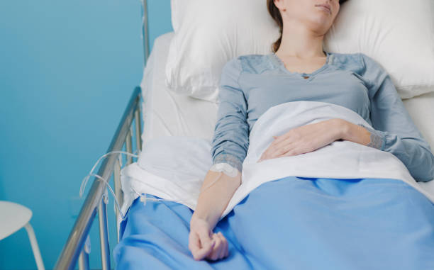 istock Patient in a hospital bed with IV drip 1201247054
