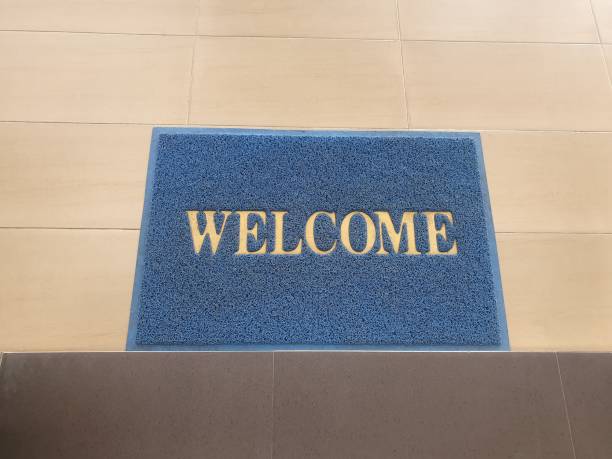 istock welcome text on old blue doormat  on floor 1201249963