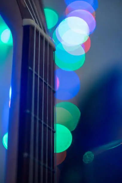 Upper part of guitar at blurred blue interior