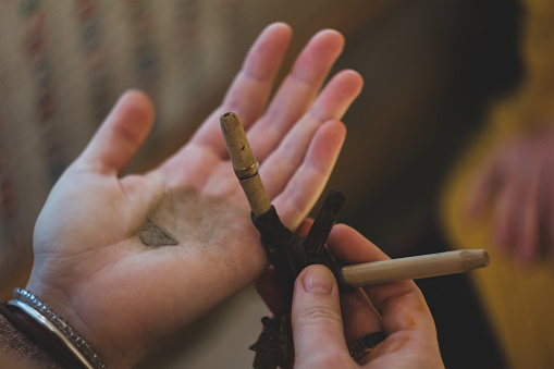 Rapee ceremony. Healing herbs and dust preparing to snuff by tepi bamboo handmade pipe