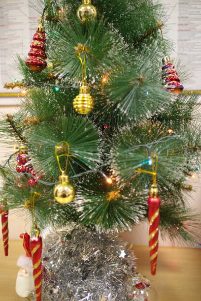 istock Artificial green Christmas tree with red toys 1201252120