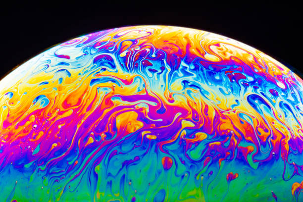 istock Macro shot of a soap bubble hemisphere. Abstract colorful liquid background. 1201252326