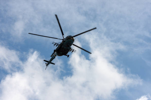 istock Military helicopter flies in the sky 1201253932