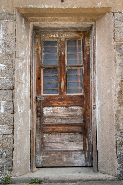 istock Old faded door at a an abandoned prison 1201255649
