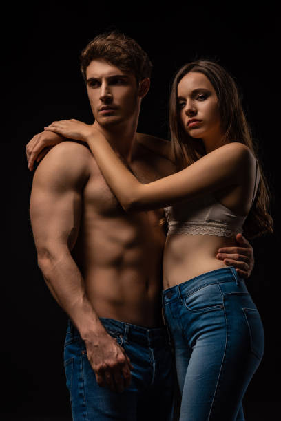 istock sexy young couple hugging isolated on black 1201256337