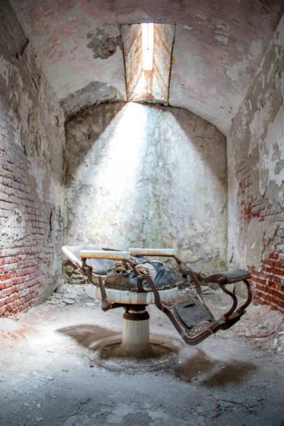istock Old barber chair in an abandoned jail cell 1201256460