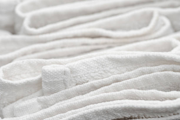 istock Close up of sloppily folded white bathroom towels 1201256900