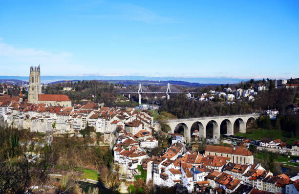 Cityscape of Fribourg, Switzerland View  on the famous city of Fribourg with St Nicolas cathedral, Zaehringen bridge and the cable-stayed Poya bridge. Beautiful view from the Loreto chapel at the Bourgillon gate. fribourg city switzerland stock pictures, royalty-free photos & images