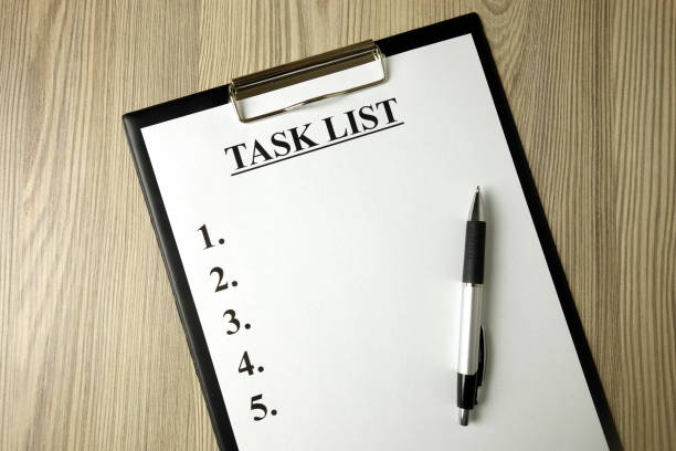 istock Clipboard with task list and pen on desk 1201262762