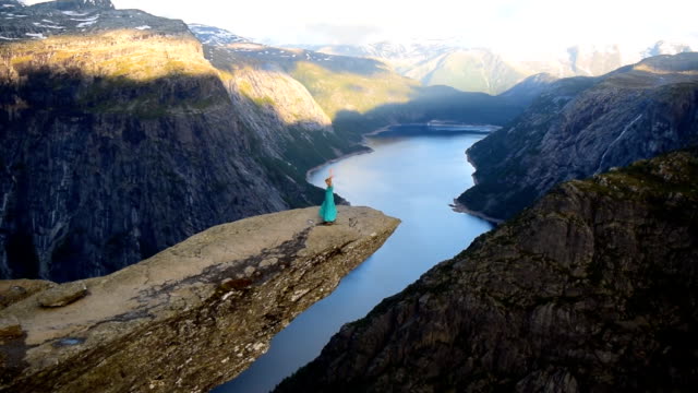 Girl on Trolltung, Norway. Slow motion video.