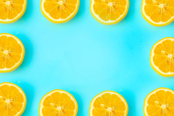 istock Summer and vitamins background frame. Lemon on a blue background, minimal food concept 1201263239