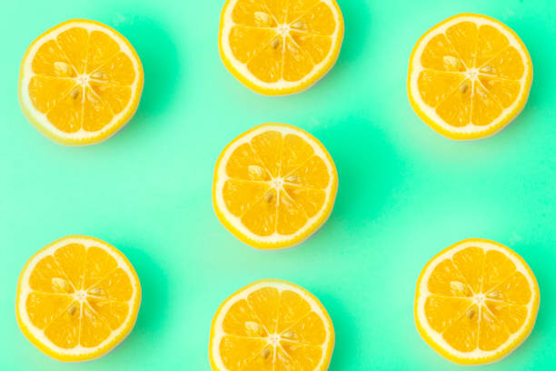 istock Summer and vitamins background. Lemon on a green background, minimal food concept 1201263241