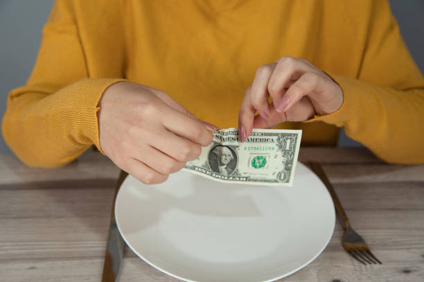 istock woman  hand  dollar on  plate 1201263839