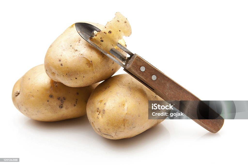 Potatoes With Potato Peeler Stock Photo - Download Image Now