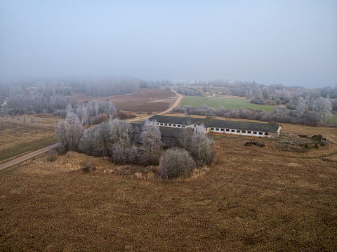 Abandoned and destruction livestock farm. Aerial view, mystical landscape view \nin the morning fog.