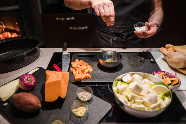 istock Man Preparing Healthy Meal At Home In Kitchen with chicken and vegetables 1201265127