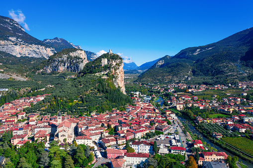 Arco, Italy - October 16, 2019: Photo taken in Italy in Arco on October 16, 2019. The photo shows the tourist city of Arco from the top point of view. Daytime. There are people in the photo.