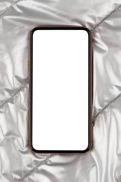 istock Smartphone with a blank white screen. New popular smartphone on silver cloth. 1201269233