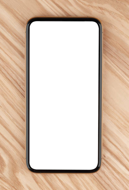 istock Smartphone with a blank white screen. New popular smartphone on a wooden surface. 1201269250