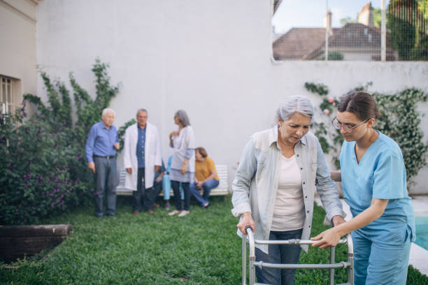 istock Nurse helping an elderly woman in using mobility walker 1201270415