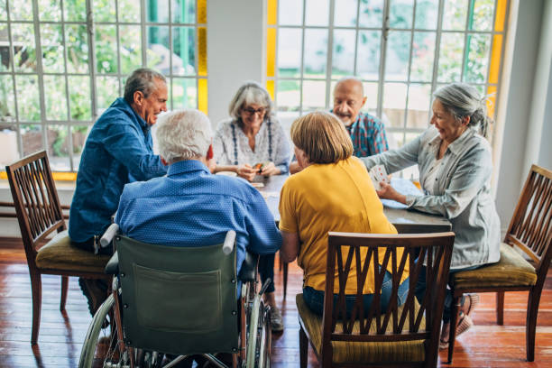 istock Group of seniors playing cards together 1201271288