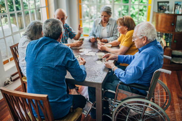 istock Group of seniors playing cards together 1201271344