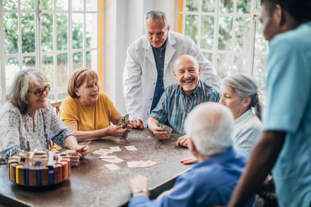 istock Group of seniors playing cards together 1201272478