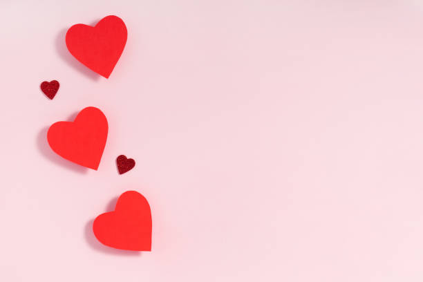 istock Valentine's day frame composition. Red hearts on pastel pink background. Top view, flat lay, copy space 1201273235