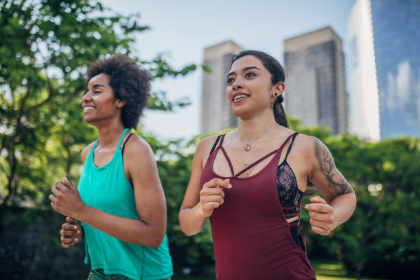istock Beautiful young women running in park. 1201274116