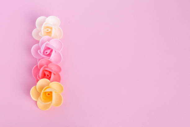 istock Waffle flowers on a pink background. Confectionery decor. The large plan. Macro. 1201274455