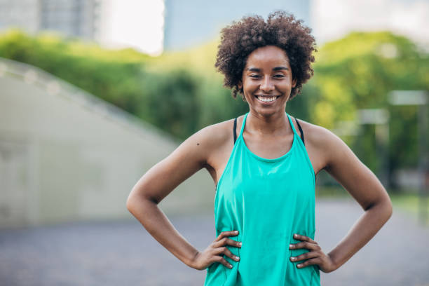 istock Beautiful young woman in park 1201274700