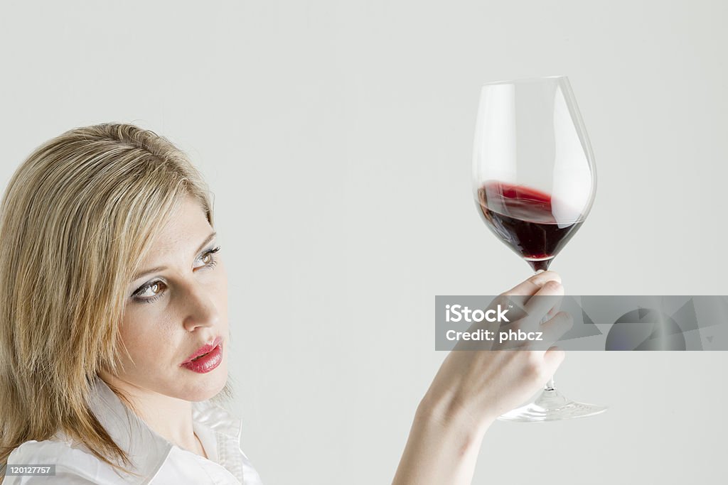 woman with red wine portrait of young woman with a glass of red wine Adult Stock Photo