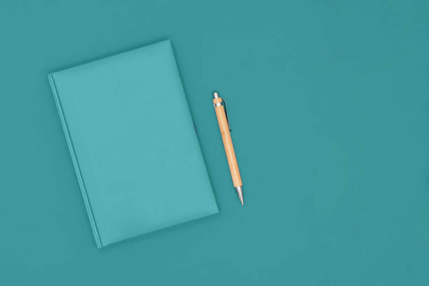 istock Notebook and pen on mint background. Business concept. Top view, flat lay, copy space. 1201280076