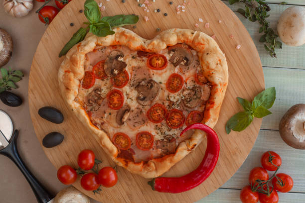 istock Pizza heart shaped on wood 1201281810