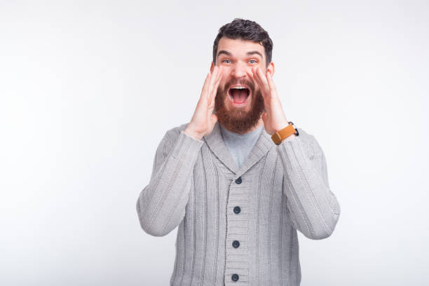 istock Surprised bearded man is shouthing at the camera some good news. 1201282744